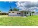 Charming single-story home features a well-maintained lawn, neutral siding and a cozy screened entrance at 2026 Arkansas Ave, Englewood, FL 34224