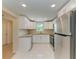 The new kitchen showcases white cabinets and stainless steel appliances at 2026 Arkansas Ave, Englewood, FL 34224