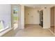 Laundry room features wood-look floors, a window with pleated shades, and a water heater at 2026 Arkansas Ave, Englewood, FL 34224