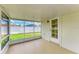Cozy screened patio with access door and view of fenced yard at 2026 Arkansas Ave, Englewood, FL 34224