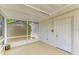 Screened in patio featuring a white door leading outside and a view of the shed at 2026 Arkansas Ave, Englewood, FL 34224