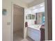 Bathroom features a single sink vanity with a walk in closet at 22321 Yonkers Ave, Port Charlotte, FL 33952