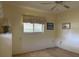 Bedroom with a ceiling fan, neutral walls, a window with blinds, and a side table with a lamp at 22321 Yonkers Ave, Port Charlotte, FL 33952