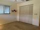 Bedroom featuring closet, neutral carpeting, and a window allowing natural light into the room at 22321 Yonkers Ave, Port Charlotte, FL 33952