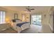 Bedroom features a neutral palette, ceiling fan, white dresser and sliding glass door at 22321 Yonkers Ave, Port Charlotte, FL 33952