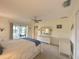 Bedroom features a neutral palette, ceiling fan, white dresser and sliding glass door at 22321 Yonkers Ave, Port Charlotte, FL 33952