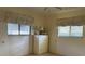 Bedroom featuring two windows with blinds, a ceiling fan and a dresser in a neutral color palette at 22321 Yonkers Ave, Port Charlotte, FL 33952