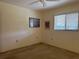 Neutral bedroom with neutral carpet, window for natural light, and artwork providing visual interest at 22321 Yonkers Ave, Port Charlotte, FL 33952