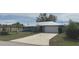 Charming single-story home with a long driveway and a well-manicured lawn and mature landscaping at 22321 Yonkers Ave, Port Charlotte, FL 33952