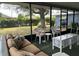 Screened lanai with comfortable seating offers a relaxing view of the landscaped backyard at 22321 Yonkers Ave, Port Charlotte, FL 33952