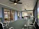 Spacious screened lanai with outdoor seating, ceiling fans, and views of the home and yard at 22321 Yonkers Ave, Port Charlotte, FL 33952