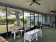 Spacious screened-in lanai providing an outdoor living area with seating and view of the backyard at 22321 Yonkers Ave, Port Charlotte, FL 33952