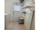 Bright laundry area with washer, dryer, shelving and easy access to an exterior door at 22321 Yonkers Ave, Port Charlotte, FL 33952