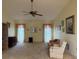 Bright and airy living room with neutral carpet, multiple windows, and ample space for furnishings at 22321 Yonkers Ave, Port Charlotte, FL 33952