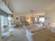 Cozy living room featuring neutral walls, neutral carpeting, and views of the adjacent dining room at 22321 Yonkers Ave, Port Charlotte, FL 33952