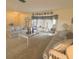 Bright living room with neutral walls, neutral carpeting, and wicker-style furniture at 22321 Yonkers Ave, Port Charlotte, FL 33952