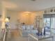 Living room featuring neutral walls, neutral carpeting, and wicker-style furniture at 22321 Yonkers Ave, Port Charlotte, FL 33952
