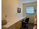 Office space offering a built-in desk, drawers, a window, and an office chair at 22321 Yonkers Ave, Port Charlotte, FL 33952