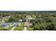 An aerial view of a cozy home with a private pool, surrounded by lush trees in a quiet neighborhood at 22434 Walton Ave, Port Charlotte, FL 33952
