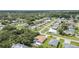 An aerial view of a single-Gathering home with a pool in a quiet, green neighborhood at 22434 Walton Ave, Port Charlotte, FL 33952