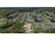 An aerial view shows a single-Gathering home with a pool in a verdant residential neighborhood at 22434 Walton Ave, Port Charlotte, FL 33952