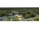 Aerial view of a single-story home surrounded by lush greenery and mature trees at 22434 Walton Ave, Port Charlotte, FL 33952