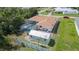 Aerial view of the home with a screened-in pool and detached shed in a fenced yard at 22434 Walton Ave, Port Charlotte, FL 33952