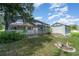 Backyard featuring an enclosed patio, shed, and landscaped area, great for outdoor living at 22434 Walton Ave, Port Charlotte, FL 33952