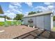 Backyard with a gravel area, quaint shed, and green chairs, perfect for gardening or relaxing at 22434 Walton Ave, Port Charlotte, FL 33952