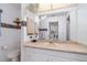 Bathroom featuring a large mirror, cream countertop, and whimsical decorative touches at 22434 Walton Ave, Port Charlotte, FL 33952