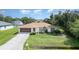 Charming single-story home with a well-maintained lawn and a two-car garage at 22434 Walton Ave, Port Charlotte, FL 33952