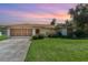 Charming single-story home with a well-maintained lawn and a two-car garage at 22434 Walton Ave, Port Charlotte, FL 33952