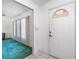 Inviting foyer with tiled floors, a white front door, and natural light from the windows at 22434 Walton Ave, Port Charlotte, FL 33952