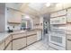 Functional kitchen featuring white appliances, tiled flooring, and ample counter space at 22434 Walton Ave, Port Charlotte, FL 33952