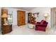 Comfortable living room featuring wood furniture, carpet, and a red accent chair at 22434 Walton Ave, Port Charlotte, FL 33952