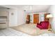 Bright living area with vaulted ceiling, wood furniture, and beige carpet at 22434 Walton Ave, Port Charlotte, FL 33952