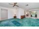 Spacious living room with carpet, slider door to pool, and view to the kitchen and dining room at 22434 Walton Ave, Port Charlotte, FL 33952