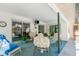 Enclosed patio with seating, a ceiling fan, and multiple sliding glass doors to the interior at 22434 Walton Ave, Port Charlotte, FL 33952
