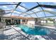 Inviting screened-in pool area with a clear blue pool and comfortable seating at 22434 Walton Ave, Port Charlotte, FL 33952