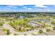 Community aerial shot showcasing pond, clubhouse, pool, playground, and surrounding homes at 226 Tapa Parish Run, Bradenton, FL 34212
