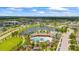 Aerial view of the community clubhouse, pool, and surrounding homes and pond at 226 Tapa Parish Run, Bradenton, FL 34212