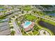 Aerial view showcases community pool, playground, green space, and roundabout surrounded by homes in a planned neighborhood at 226 Tapa Parish Run, Bradenton, FL 34212