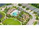 Aerial view featuring the community pool, playground, green space, and surrounding neighborhood at 226 Tapa Parish Run, Bradenton, FL 34212