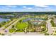 Aerial view of neighborhood featuring community pool, pond, and landscaped common areas at 226 Tapa Parish Run, Bradenton, FL 34212