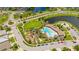 Aerial view of a community pool, playground, and green space surrounded by palm trees and residential homes at 226 Tapa Parish Run, Bradenton, FL 34212