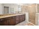 Beautiful bathroom featuring double sinks, granite countertops, and a glass-enclosed shower at 226 Tapa Parish Run, Bradenton, FL 34212