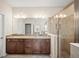 Elegant bathroom with a glass shower, double sink vanity with granite countertops, and lots of natural light at 226 Tapa Parish Run, Bradenton, FL 34212