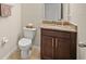 Small bathroom with granite vanity, toilet, and dark cabinets at 226 Tapa Parish Run, Bradenton, FL 34212