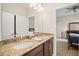 Bathroom featuring double vanity, granite countertops, and a view into the bedroom at 226 Tapa Parish Run, Bradenton, FL 34212