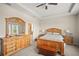 Spacious bedroom with light wood furniture, carpeted floors, and an ensuite bathroom at 226 Tapa Parish Run, Bradenton, FL 34212